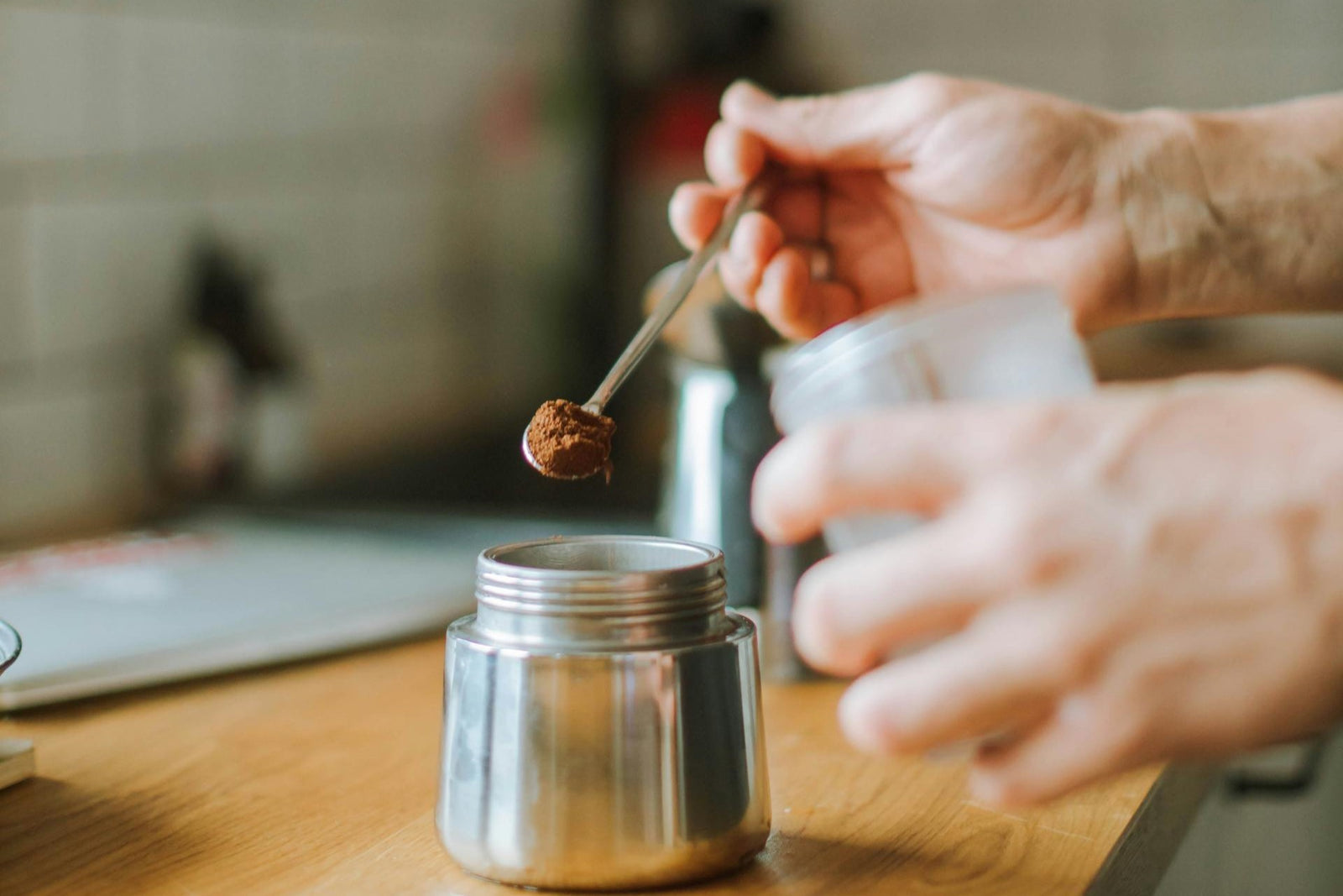 preparing coffee at home with a stovetop coffee maker